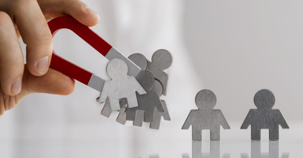 A magnet collecting metal in the shape of people.