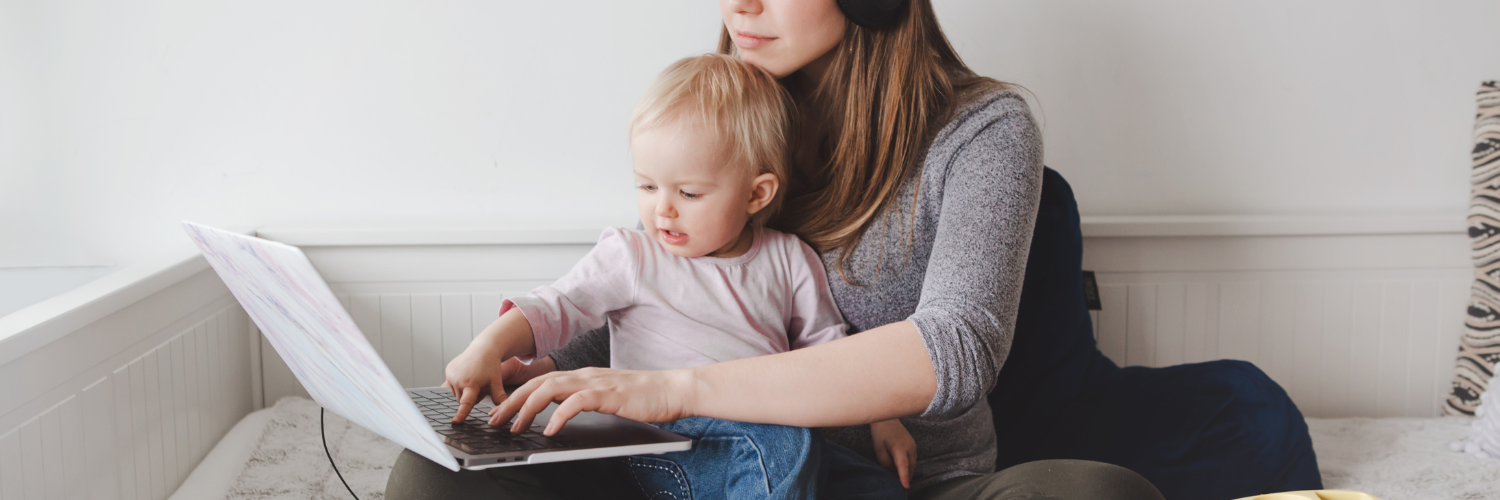 a women and her child on a laptop working from home